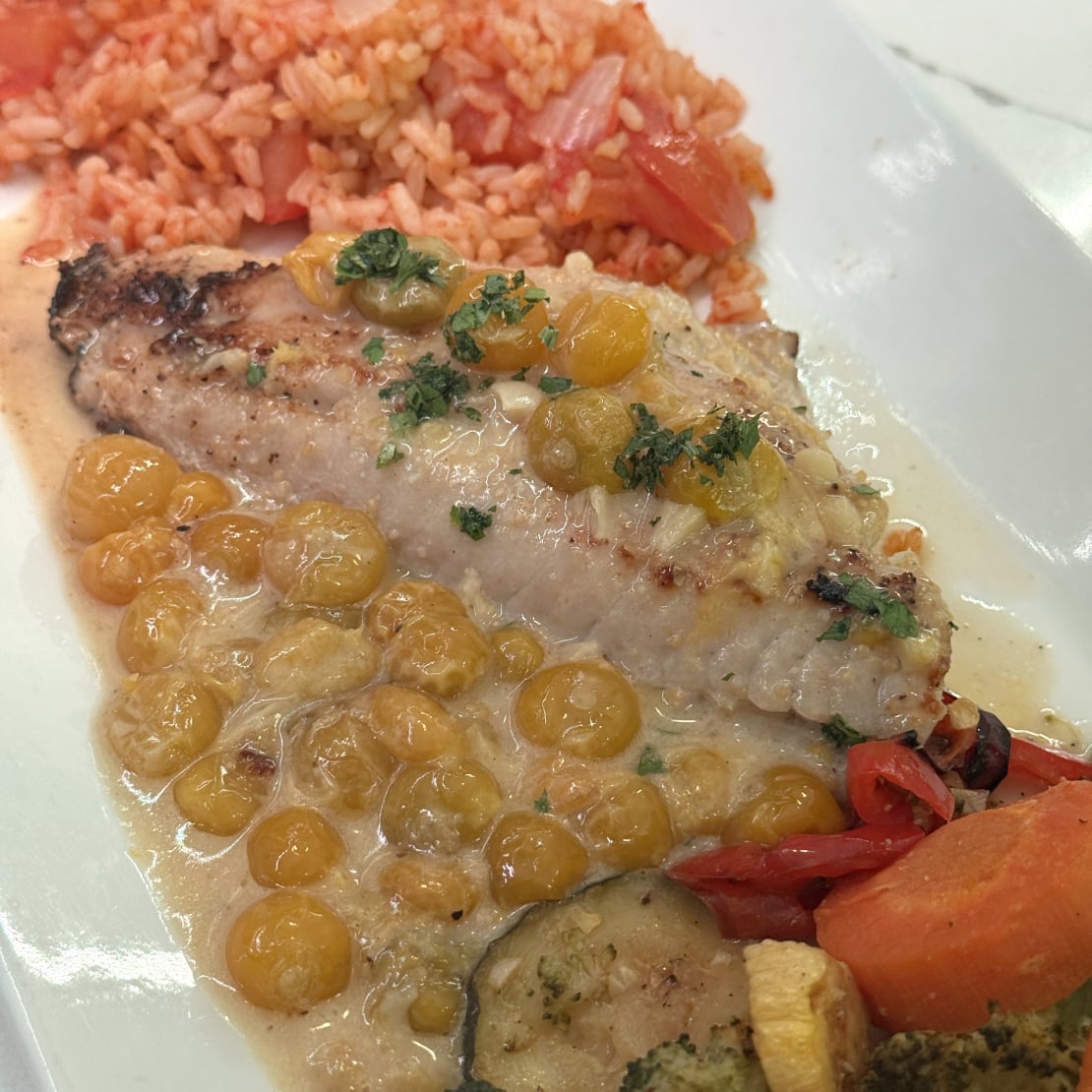 Black fish with husked tomatoes